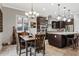 A kitchen with dark cabinets, stainless steel appliances, and an island with bar seating at 19748 E Walnut Rd, Queen Creek, AZ 85142