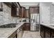 Modern kitchen with stainless steel appliances, granite countertops, and stylish backsplash, offering a gourmet cooking experience at 19748 E Walnut Rd, Queen Creek, AZ 85142