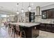 Elegant kitchen features a large island with counter seating, pendant lighting, and stainless steel appliances at 19748 E Walnut Rd, Queen Creek, AZ 85142