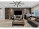 Cozy living room with a modern stone accent wall, stylish furniture, and an inviting atmosphere at 19748 E Walnut Rd, Queen Creek, AZ 85142