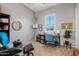 Cozy home office with a comfortable chair, a desk, and natural light from a window at 19748 E Walnut Rd, Queen Creek, AZ 85142