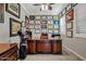 Charming office features an impressive desk, golf decor, and ample natural light at 19748 E Walnut Rd, Queen Creek, AZ 85142