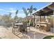 The outdoor bar and dining area are shaded by a pergola and features a misting system at 19748 E Walnut Rd, Queen Creek, AZ 85142