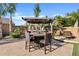 Outdoor dining area features a bar and pergola with seating at 19748 E Walnut Rd, Queen Creek, AZ 85142