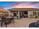 Spacious covered patio with outdoor seating, a putting green, and views of the pool area at 19748 E Walnut Rd, Queen Creek, AZ 85142