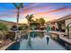 Resort-style pool with palm trees, an outdoor kitchen, and an inviting lounge area at 19748 E Walnut Rd, Queen Creek, AZ 85142