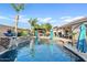 The in-ground pool features a rock waterfall and tropical landscaping at 19748 E Walnut Rd, Queen Creek, AZ 85142
