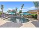 The backyard features a large pool with a rock waterfall and tropical landscaping at 19748 E Walnut Rd, Queen Creek, AZ 85142