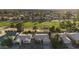 Aerial view of a neighborhood backing onto a golf course with water features at 19906 N 76Th Ave, Glendale, AZ 85308