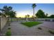 A landscaped backyard with artificial turf, a built-in grill, and views of the surrounding golf course at 19906 N 76Th Ave, Glendale, AZ 85308