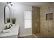 Updated bathroom features a tiled walk-in shower and modern vanity at 19906 N 76Th Ave, Glendale, AZ 85308