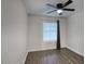 Well-lit bedroom with wood-look floors and a ceiling fan for added comfort at 19906 N 76Th Ave, Glendale, AZ 85308