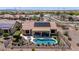 Drone shot of pool, patio, desert landscaping, and solar panels, highlighting outdoor living and energy efficiency at 20655 N 273Rd Ave, Buckeye, AZ 85396