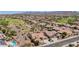 Wide aerial shot showcasing a neighborhood with golf course, desert landscape, and mountain views at 20655 N 273Rd Ave, Buckeye, AZ 85396