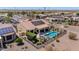 Scenic aerial view of backyard oasis featuring a pool, patio, lush desert landscaping, and a wrought iron fence at 20655 N 273Rd Ave, Buckeye, AZ 85396