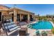Inviting backyard features a pool, covered patio with seating, and a relaxing swing for outdoor enjoyment at 20655 N 273Rd Ave, Buckeye, AZ 85396
