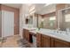 Bathroom showcasing double sinks, granite countertops, and neutral wall colors at 20655 N 273Rd Ave, Buckeye, AZ 85396