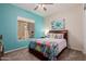 Bedroom featuring a colorful cactus theme, large window, and carpeted floor at 20655 N 273Rd Ave, Buckeye, AZ 85396