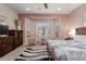 Comfortable bedroom featuring a bay window, carpeted floor, and stylish decor at 20655 N 273Rd Ave, Buckeye, AZ 85396