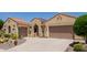 Inviting home exterior with dual garages, desert landscaping, and a quaint front walkway at 20655 N 273Rd Ave, Buckeye, AZ 85396