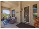Cozy front porch with comfortable seating, a decorative screen door, and desert views at 20655 N 273Rd Ave, Buckeye, AZ 85396