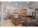 Well-lit kitchen boasting stainless steel appliances, an island, and travertine tile flooring at 20655 N 273Rd Ave, Buckeye, AZ 85396