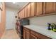 Bright laundry room with plentiful storage, modern appliances, and neutral colors at 20655 N 273Rd Ave, Buckeye, AZ 85396