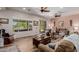 Bright living room with wood floors, comfortable seating, and a view of the backyard at 20655 N 273Rd Ave, Buckeye, AZ 85396