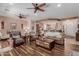 Spacious living room with wood floors, comfortable seating, and an open layout to the kitchen at 20655 N 273Rd Ave, Buckeye, AZ 85396