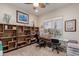 Office space showcasing a work area, large window, built-in shelves, and carpeted floor at 20655 N 273Rd Ave, Buckeye, AZ 85396