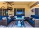 Comfortable outdoor seating area with wicker sofas, a coffee table, and ceiling fan on the covered patio at 20655 N 273Rd Ave, Buckeye, AZ 85396