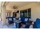 Inviting covered patio with comfortable seating, a ceiling fan, and a TV, creating the perfect space for outdoor relaxation at 20655 N 273Rd Ave, Buckeye, AZ 85396