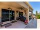 Expansive covered patio with outdoor seating, and desert landscaping, seamlessly blending indoor and outdoor living spaces at 20655 N 273Rd Ave, Buckeye, AZ 85396