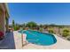 Inviting backyard pool with surrounding desert landscape and wrought iron fence at 20655 N 273Rd Ave, Buckeye, AZ 85396
