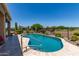 Sparkling pool surrounded by desert landscaping and a black fence, offering a private outdoor retreat at 20655 N 273Rd Ave, Buckeye, AZ 85396
