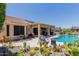Backyard pool area surrounded by desert landscaping with a covered patio and lounge area, perfect for outdoor entertaining at 20655 N 273Rd Ave, Buckeye, AZ 85396