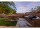 Well-maintained backyard with an outdoor kitchen, landscaped garden, BBQ, and privacy fence at 20689 W Valley View Dr, Buckeye, AZ 85396