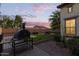 Backyard with outdoor kitchen, pizza oven, manicured landscaping, and views for relaxation at 20689 W Valley View Dr, Buckeye, AZ 85396