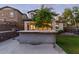 Backyard with outdoor kitchen, shaded patio, green lawn, and mature landscaping for a private retreat at 20689 W Valley View Dr, Buckeye, AZ 85396