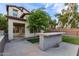 Backyard featuring a built-in counter, covered patio, and well-maintained lawn at 20689 W Valley View Dr, Buckeye, AZ 85396