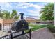 Backyard featuring a pizza oven and a lush green lawn, perfect for outdoor entertaining at 20689 W Valley View Dr, Buckeye, AZ 85396