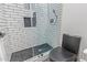 Modern bathroom featuring black commode, shower with glass door and subway tile, and tiled floors at 20689 W Valley View Dr, Buckeye, AZ 85396