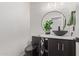 Half bath features a black vessel sink, geometric tile, and a black toilet and fixtures at 20689 W Valley View Dr, Buckeye, AZ 85396
