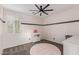 Clean bedroom with neutral walls, ceiling fan, gray carpet, and a white changing table at 20689 W Valley View Dr, Buckeye, AZ 85396