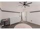 Bright bedroom features a ceiling fan, neutral carpet, white trim, and a white dresser at 20689 W Valley View Dr, Buckeye, AZ 85396
