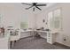 Bright bedroom with white vanity, two windows, neutral walls, and gray carpet at 20689 W Valley View Dr, Buckeye, AZ 85396