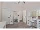 Bedroom features gray carpet, neutral paint, a standing mirror, and a white vanity with mirror at 20689 W Valley View Dr, Buckeye, AZ 85396