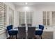 Dining room features a glass table and blue upholstered chairs at 20689 W Valley View Dr, Buckeye, AZ 85396
