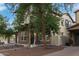 Two-story home with brick and stucco exterior, a covered porch, and mature landscaping at 20689 W Valley View Dr, Buckeye, AZ 85396