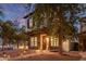 Two-story home showcasing stone accents and a balcony, complemented by meticulous landscaping and walkway lights at 20689 W Valley View Dr, Buckeye, AZ 85396